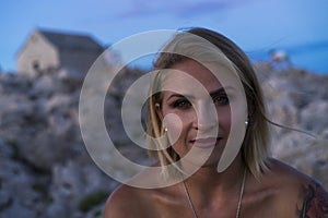 Beautiful portrait of blonde caucasian woman outdoor at Adriatic Sea in Croatia Europe