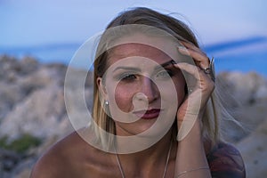 Beautiful portrait of blonde caucasian woman outdoor at Adriatic Sea in Croatia Europe