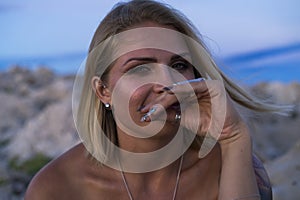 Beautiful portrait of blonde caucasian woman outdoor at Adriatic Sea in Croatia Europe