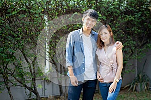 Beautiful portrait couple looking each others eyes and smiling with happy, young asian man and woman relation
