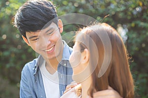 Beautiful portrait couple looking each others eyes and smiling with happy, young asian man and woman relation with love dating