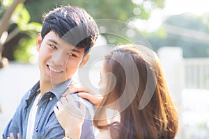 Beautiful portrait couple looking each others eyes and smiling with happy, young asian man and woman relation with love dating