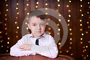 Beautiful portrait. Cute little boy. Brown background