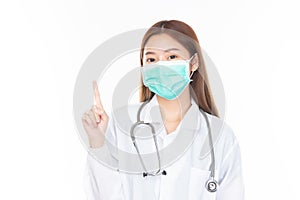 Beautiful portrait friendly asian female doctor or nurse in medical mask pointing with finger at medical clinic isolated on white