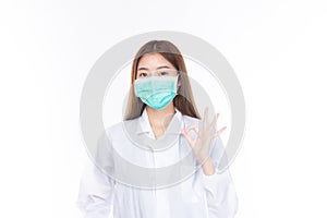 Beautiful portrait friendly asian female doctor or nurse wear medical mask at medical clinic isolated on white background. Mask to