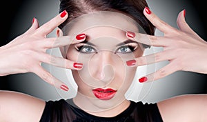 Beautiful portrait of a girl with red lips and nails