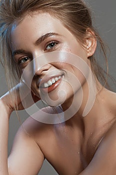 Beautiful portrait of a girl with wet make-up and shiny skin