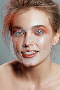Beautiful portrait of a girl with wet make-up and shiny skin