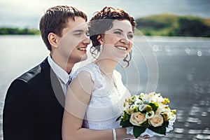 Beautiful portrait of happy bride and groom on the background of nature. Newlyweds close-up