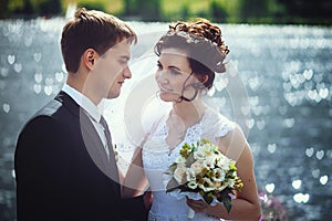 Beautiful portrait of happy bride and groom on the background of nature. Newlyweds close-up