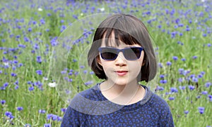 Beautiful portrait of happy child with sunglasses for childhood wellbeing