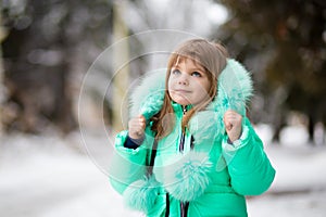 Beautiful portrait of little child enjoying winter