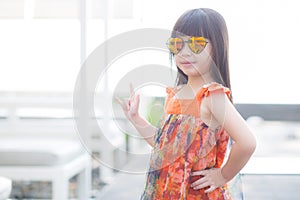 Beautiful portrait little girl asian of a smiling standing at swimming pool
