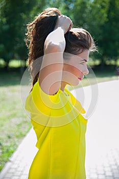 Beautiful portrait of sport woman touching her long hairs