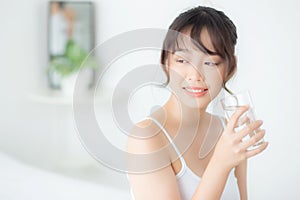 Beautiful portrait young asian woman caucasian smiling with nutrition thirsty and drinking glass of water