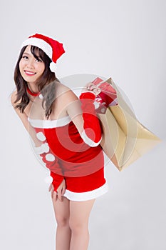 Beautiful portrait young asian woman happy and excited holding paper bag with gift box in xmas holiday isolated