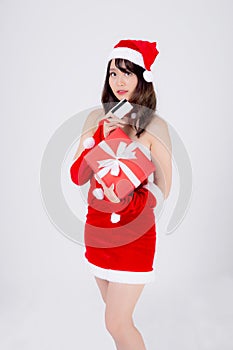 Beautiful portrait young asian woman happy holding credit card and red gift box in Christmas holiday isolated on white background