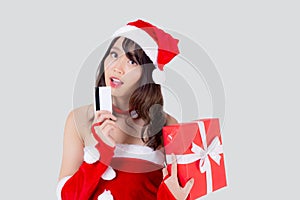 Beautiful portrait young asian woman happy holding credit card and red gift box in Christmas holiday isolated.