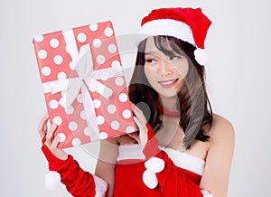 Beautiful portrait young asian woman happy holding red gift box with excited in xmas holiday isolated on white background