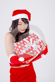 Beautiful portrait young asian woman happy holding red gift box with excited in xmas holiday isolated on white background