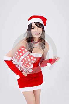 Beautiful portrait young asian woman happy holding red gift box with excited in xmas holiday isolated on white background