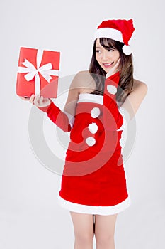Beautiful portrait young asian woman happy holding red gift box with excited in xmas holiday isolated on white background