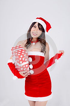 Beautiful portrait young asian woman happy holding red gift box with excited in xmas holiday  on white background