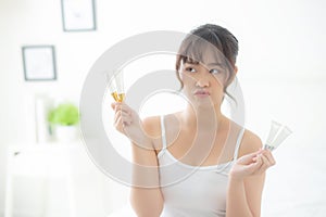 Beautiful portrait young asian woman holding and presenting cream or lotion product