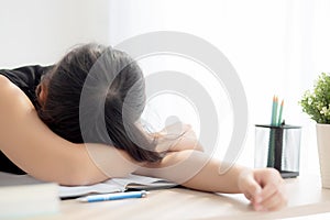 Beautiful portrait young asian woman learning exam or homework and sleep with tired and stress