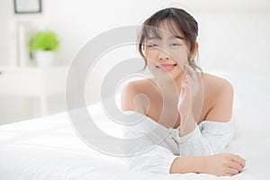 Beautiful portrait young asian woman lying and smile while wake up with sunrise at morning, girl with happy