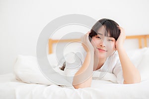 Beautiful portrait young asian woman lying and smile while wake up with sunrise at morning, girl with happy annd fun