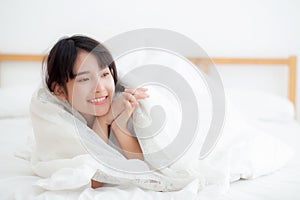 Beautiful portrait young asian woman lying and smile while wake up with sunrise at morning, girl with happy and fun