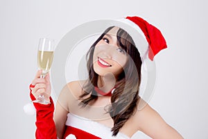 Beautiful portrait young asian woman in Santa holding glass of champagne with party celebrating in xmas holiday isolated