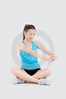 Beautiful portrait young asian woman sitting stretch muscle arm workout isolated on white background