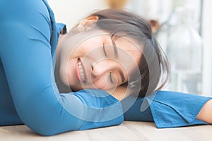 Beautiful portrait young asian woman smiling sleep at cafe, model girl happy with relax and resting, female lying