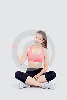 Beautiful portrait young asian woman in sport clothes with satisfied and confident presenting and show something