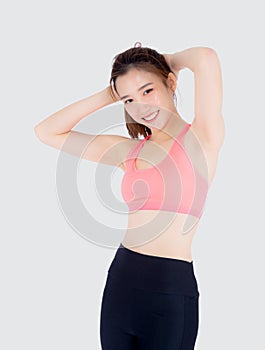 Beautiful portrait young asian woman standing stretch muscle arm isolated on white background