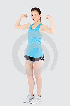 Beautiful portrait young asian woman wear sport clothes have strong and muscle with health, girl show biceps with exercise