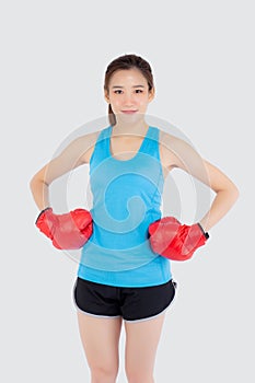 Beautiful portrait young asian woman wearing red boxing gloves with strength and strength isolated on white background
