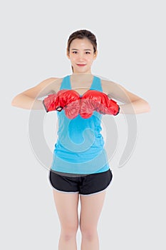 Beautiful portrait young asian woman wearing red boxing gloves with strength and strength isolated on white background