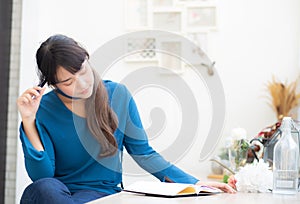 Beautiful portrait young asian woman writer smiling thinking idea and writing on notebook or diary with happy, lifestyle of asian