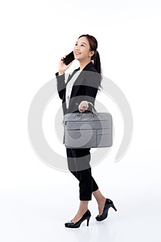 Beautiful portrait young business asian woman holding a briefcase and talking phone.