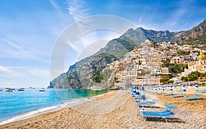 Beautiful Positano with colorful architecture on hills leading down to coast, comfortable beaches and azure sea on Amalfi Coast in