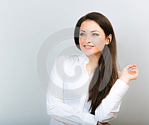 Beautiful positive business happy woman in white shirt showing idea sign by finger and looking up in white shirt