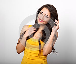 Beautiful positive happy woman in yellow shirt and long hair too