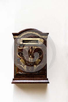 Postbox isolated on a white wall