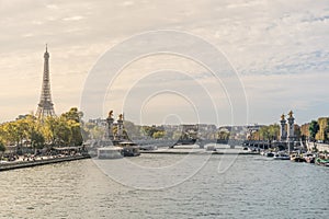 Beautiful postcard view of the Seine river crossing the Paris city in France, with tourist attraction boats in the