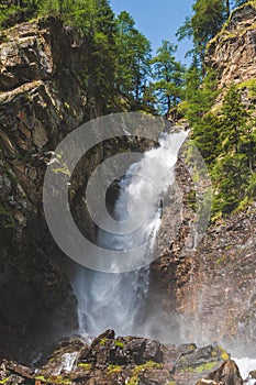 Beautiful waterfall in a wood on the Italian Dolomites