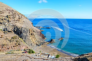 Beautiful Prainha Beach by the Atlantic Ocean in Madeira, Portugal. Surrounded by volcanic landscape and cliffs, people on the photo