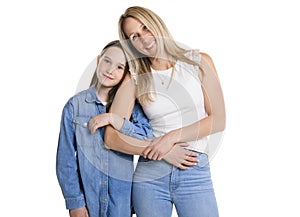 Beautiful pre teen girl with mother on studio white background